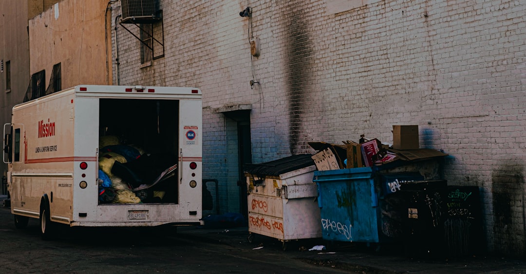 white van parked beside gray concrete wall